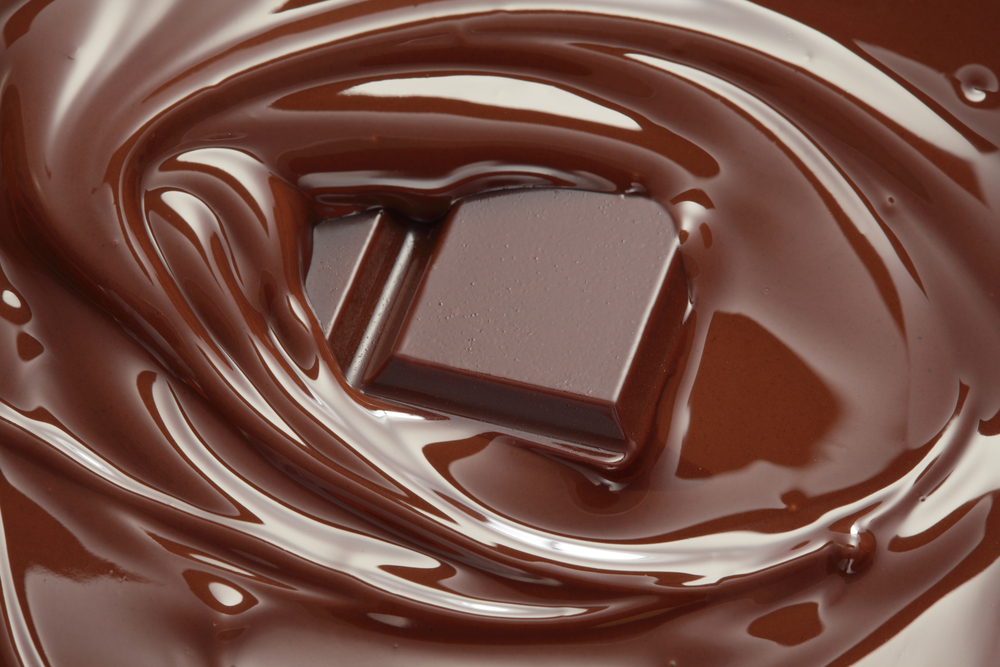 A square of chocolate surrounded by melted chocolate.