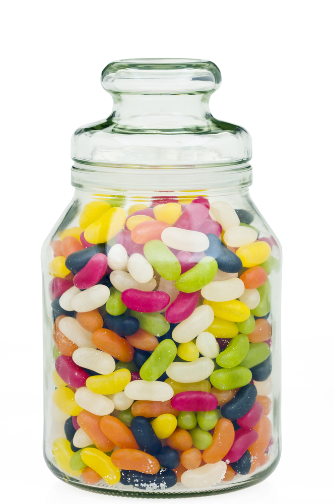 A glass jar full of colorful jelly beans.