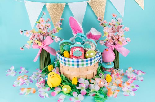An Easter basket filled with Candy Club spring candies decorated with flowers