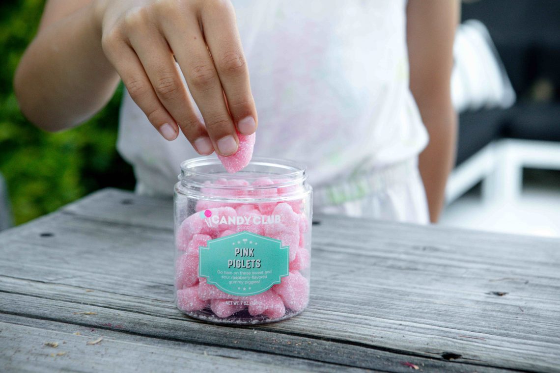 Grabbing gummy Pink Piglets candy. Perfect candy gift for long distance.